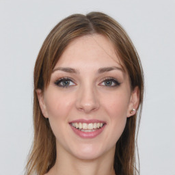 Joyful white young-adult female with long  brown hair and grey eyes