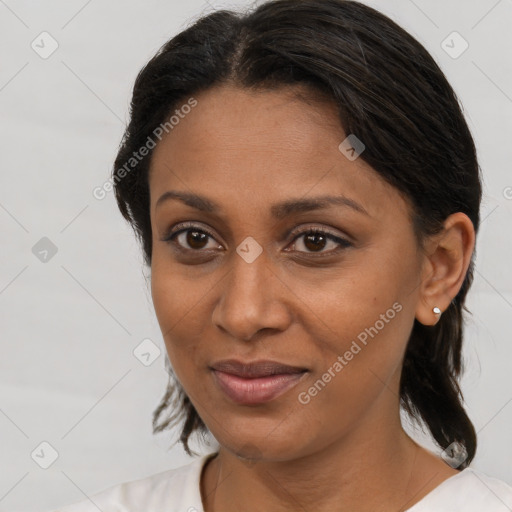 Joyful black young-adult female with medium  brown hair and brown eyes