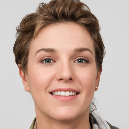 Joyful white young-adult female with short  brown hair and grey eyes