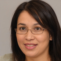 Joyful white adult female with long  brown hair and brown eyes