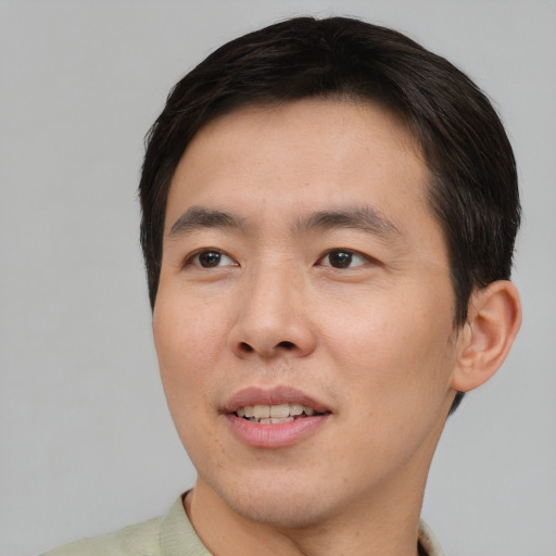 Joyful asian young-adult male with short  brown hair and brown eyes