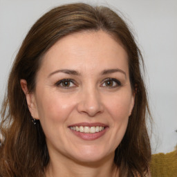 Joyful white adult female with medium  brown hair and brown eyes