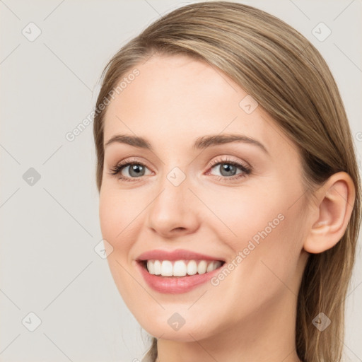 Joyful white young-adult female with long  brown hair and blue eyes