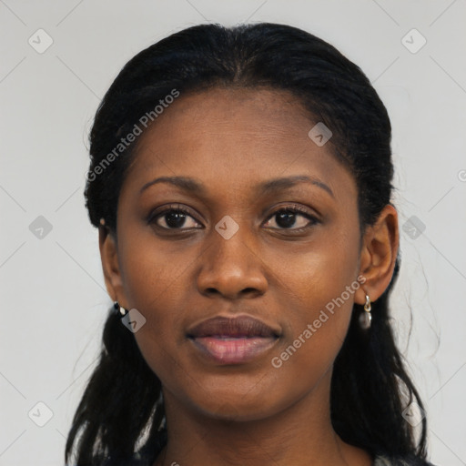 Joyful black young-adult female with long  black hair and brown eyes