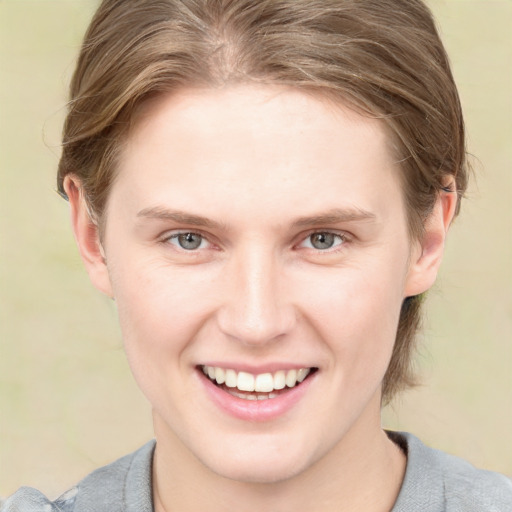 Joyful white young-adult female with medium  brown hair and blue eyes