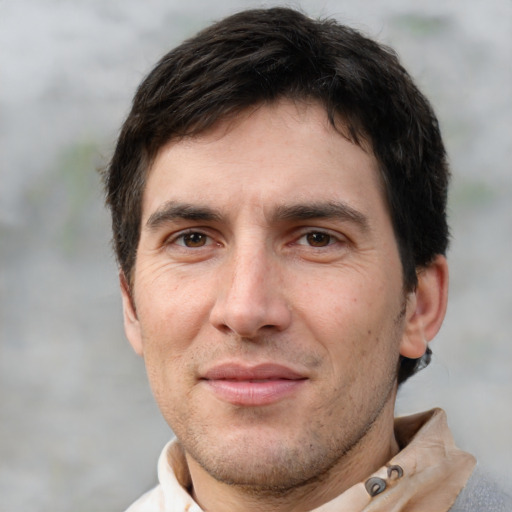 Joyful white adult male with short  brown hair and brown eyes