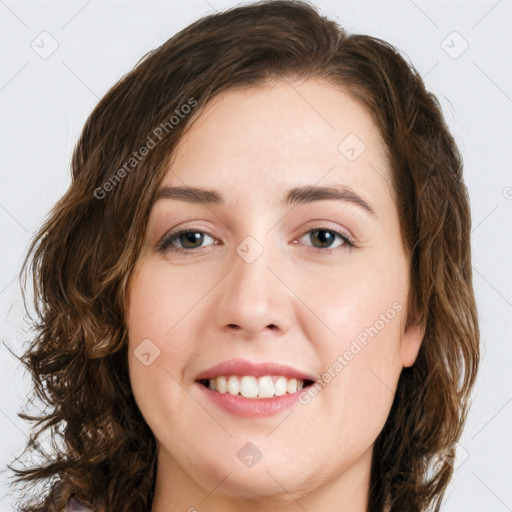 Joyful white young-adult female with long  brown hair and green eyes