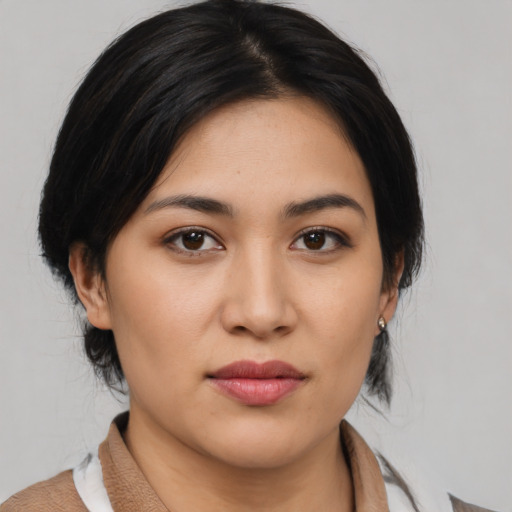 Joyful asian young-adult female with medium  brown hair and brown eyes