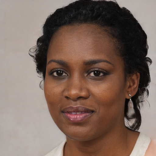 Joyful black young-adult female with medium  black hair and brown eyes