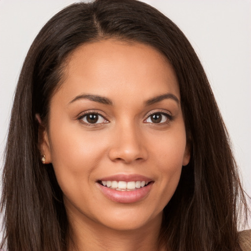 Joyful white young-adult female with long  brown hair and brown eyes