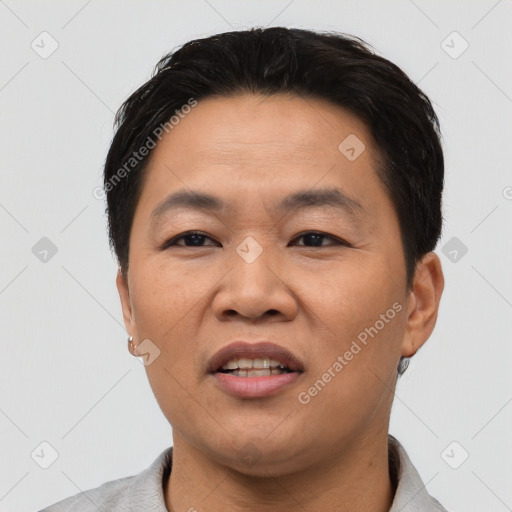 Joyful asian adult male with short  black hair and brown eyes