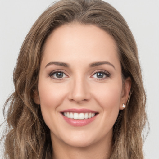 Joyful white young-adult female with long  brown hair and green eyes