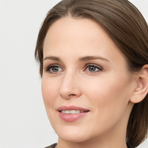 Joyful white young-adult female with medium  brown hair and grey eyes