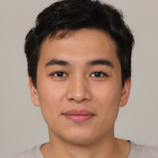 Joyful asian young-adult male with short  brown hair and brown eyes