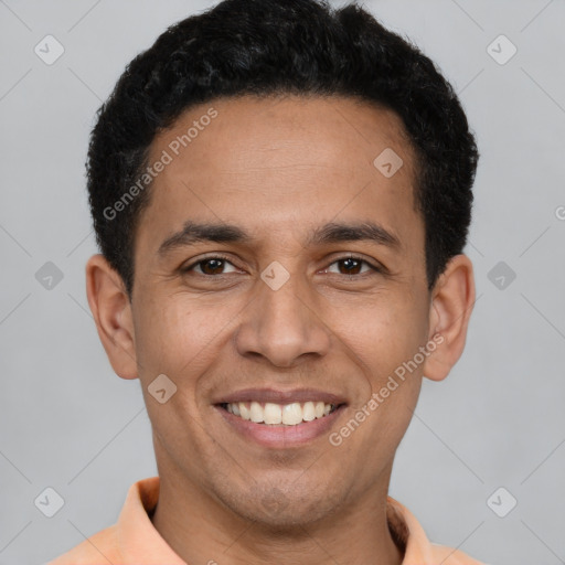 Joyful latino young-adult male with short  brown hair and brown eyes