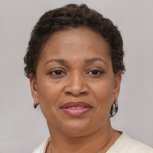 Joyful latino adult female with short  brown hair and brown eyes