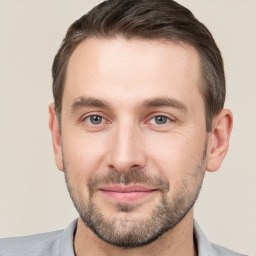 Joyful white young-adult male with short  brown hair and brown eyes