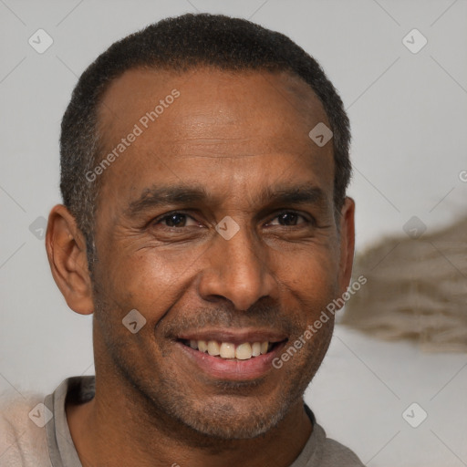 Joyful black adult male with short  brown hair and brown eyes