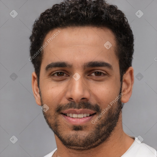 Joyful white young-adult male with short  black hair and brown eyes