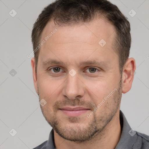 Joyful white adult male with short  brown hair and brown eyes