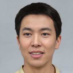 Joyful asian young-adult male with short  black hair and brown eyes