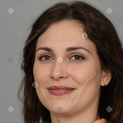 Joyful white adult female with long  brown hair and brown eyes