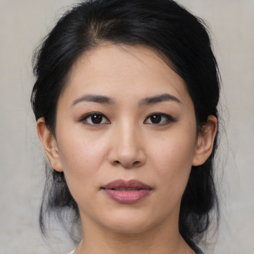Joyful asian young-adult female with medium  black hair and brown eyes