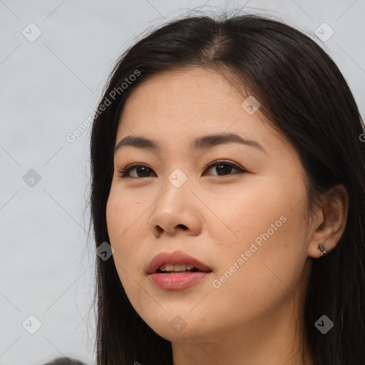 Joyful asian young-adult female with long  brown hair and brown eyes