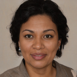 Joyful black adult female with medium  brown hair and brown eyes