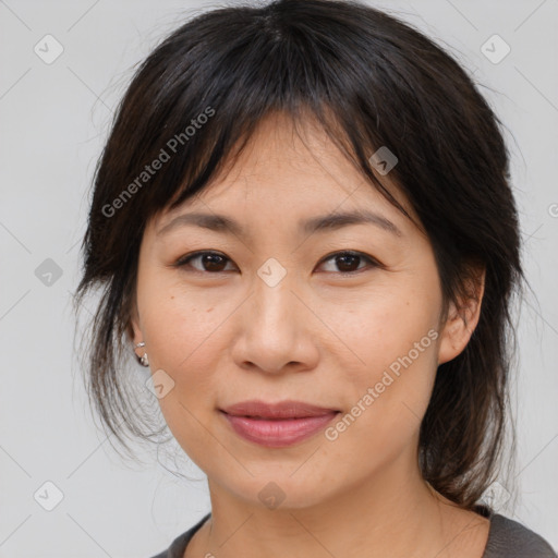 Joyful asian young-adult female with medium  brown hair and brown eyes