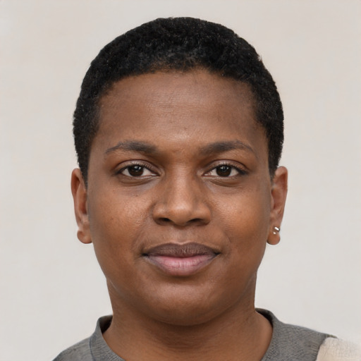 Joyful black young-adult female with short  black hair and brown eyes