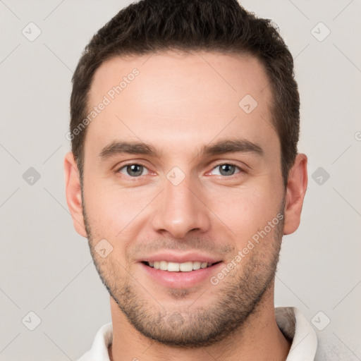 Joyful white young-adult male with short  brown hair and brown eyes