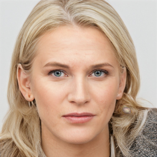 Joyful white young-adult female with long  brown hair and blue eyes