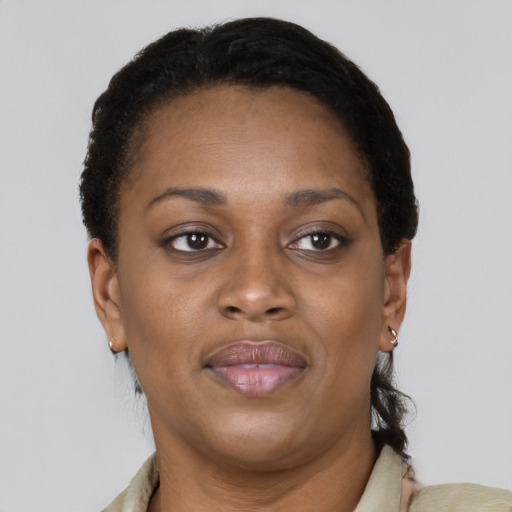 Joyful black adult female with short  brown hair and brown eyes
