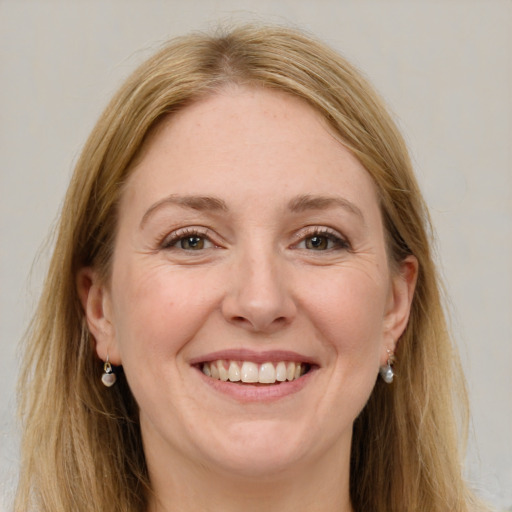 Joyful white adult female with long  brown hair and grey eyes