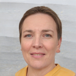 Joyful white adult female with short  brown hair and grey eyes