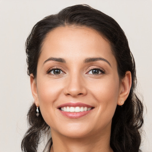 Joyful white young-adult female with medium  brown hair and brown eyes