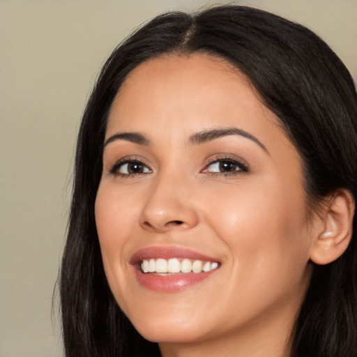 Joyful white young-adult female with long  black hair and brown eyes