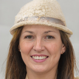 Joyful white adult female with long  brown hair and brown eyes