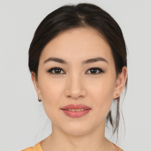 Joyful asian young-adult female with medium  brown hair and brown eyes