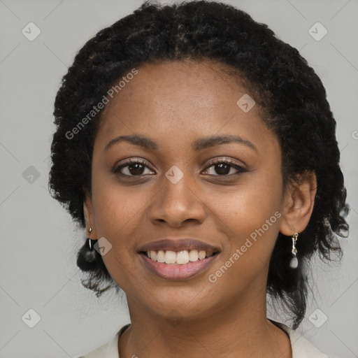 Joyful black young-adult female with long  black hair and brown eyes