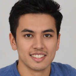 Joyful latino young-adult male with short  brown hair and brown eyes