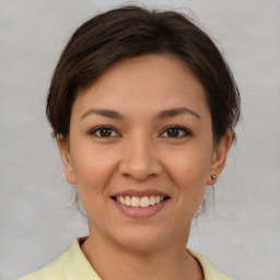 Joyful white young-adult female with medium  brown hair and brown eyes