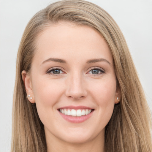 Joyful white young-adult female with long  brown hair and grey eyes