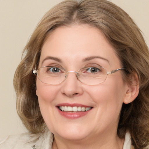 Joyful white adult female with medium  brown hair and green eyes