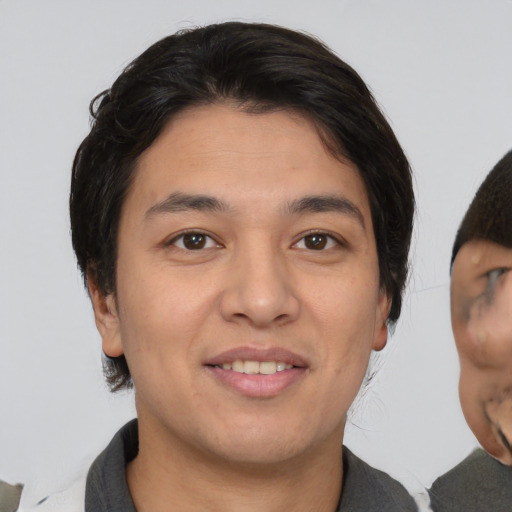 Joyful asian young-adult male with medium  brown hair and brown eyes