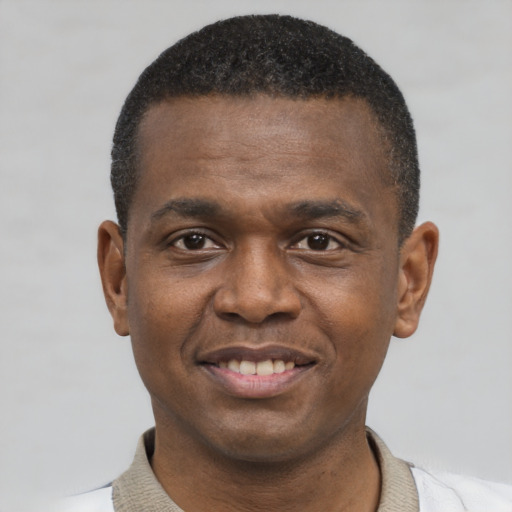 Joyful latino young-adult male with short  brown hair and brown eyes
