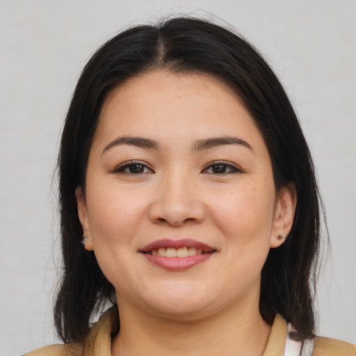 Joyful white young-adult female with medium  brown hair and brown eyes