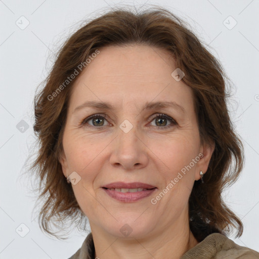 Joyful white adult female with medium  brown hair and brown eyes