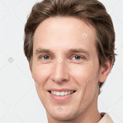 Joyful white adult male with short  brown hair and grey eyes